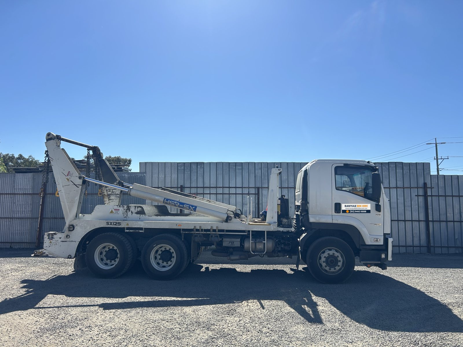 Isuzu FVZ skip loader truck, side view