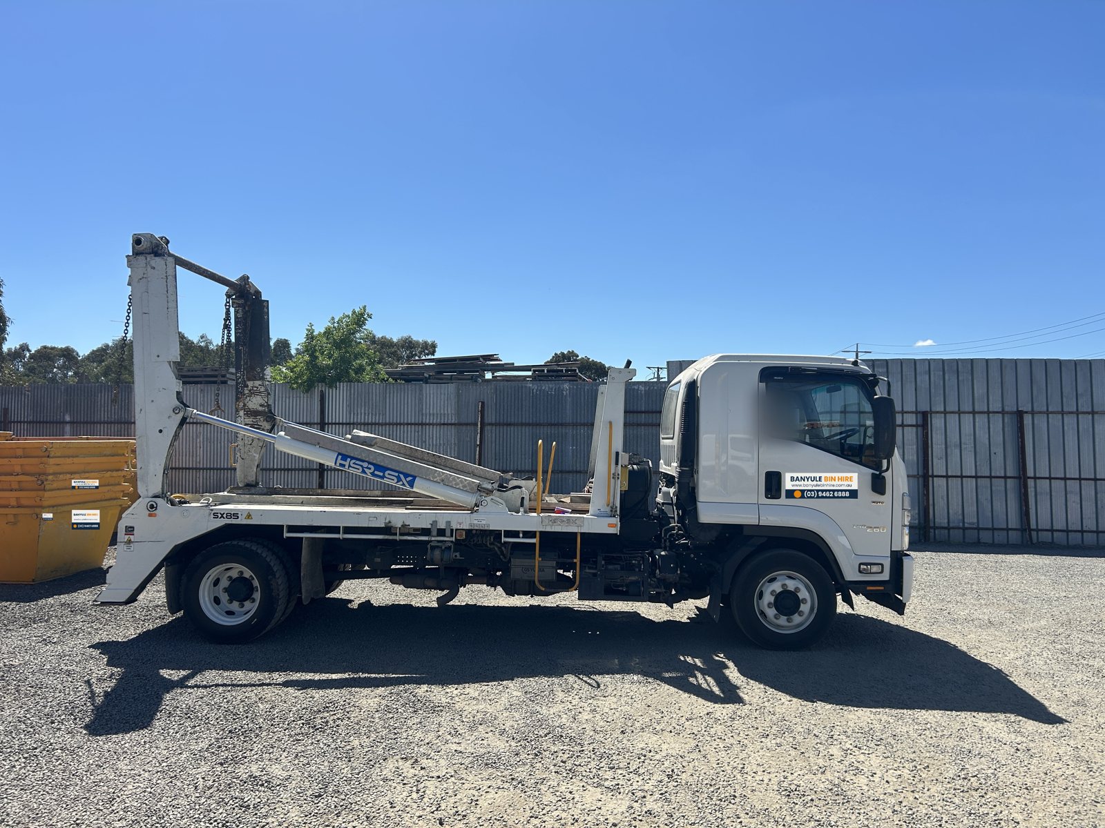 Isuzu FSR skip loader truck, side view